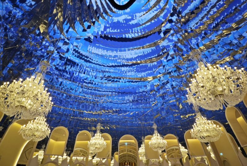 Raffles Doha main lobby with blue chandelier ceiling